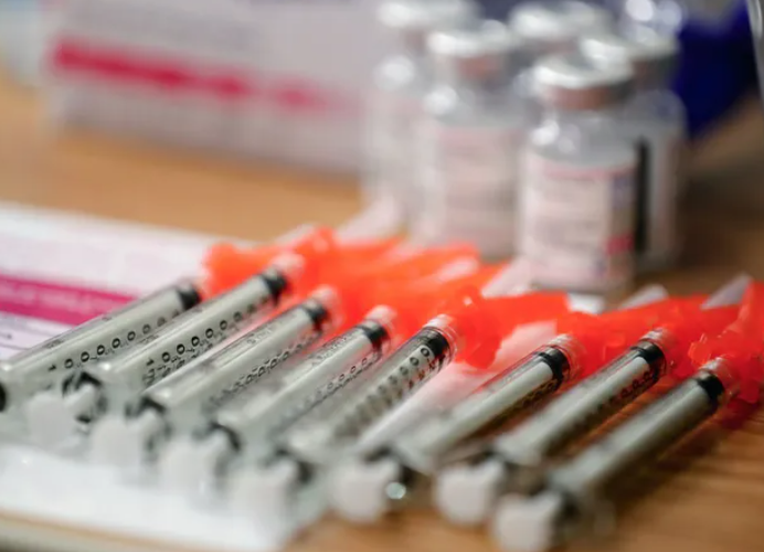 Medical staff prepare Moderna COVID-19 vaccines at Seattle’s Children’s in 2022. The Trump administration said Tuesday it would restrict availability of the COVID vaccine to older adults and people at higher risk for severe disease. (Erika Schultz / The Seattle Times)