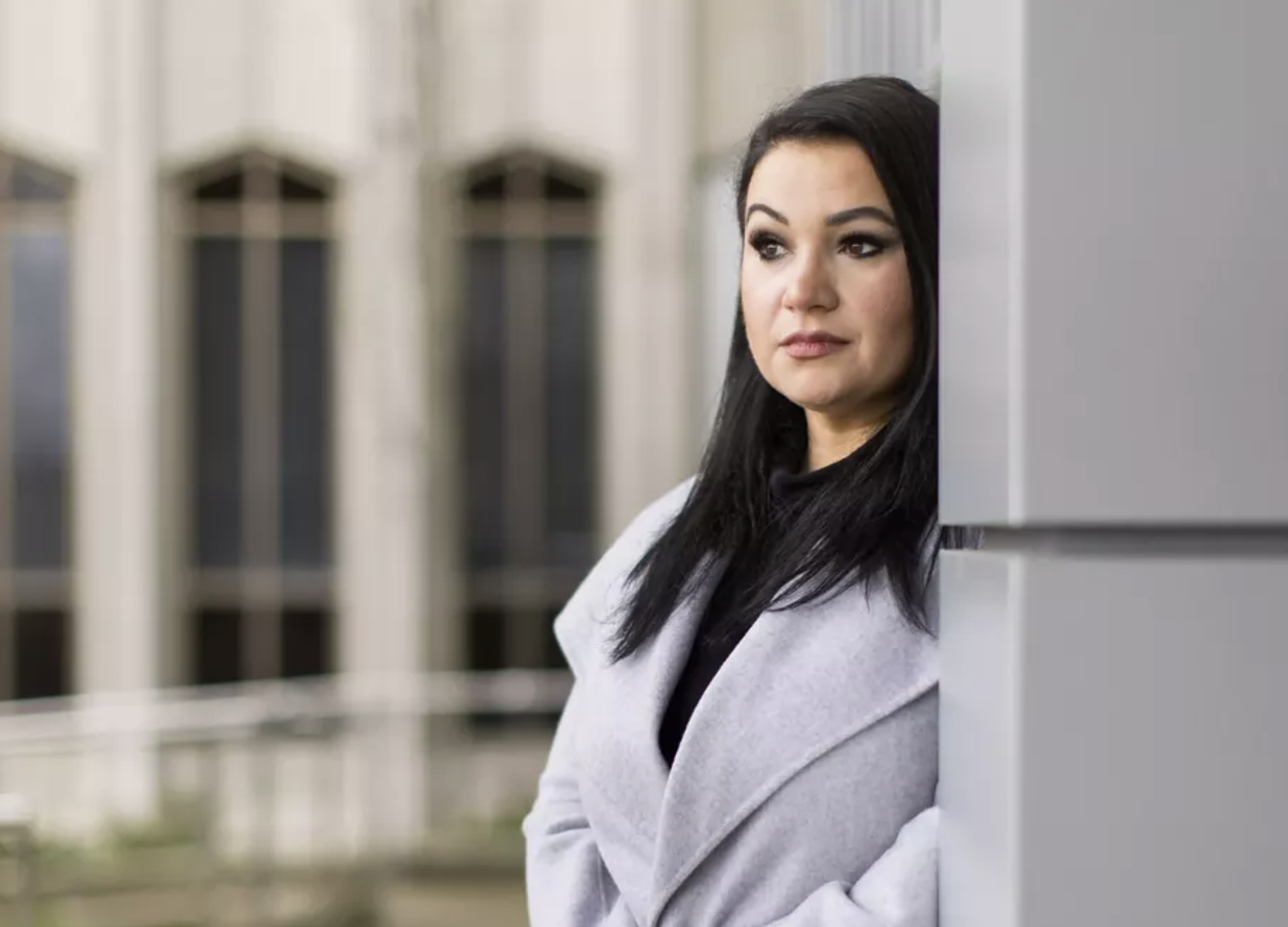 Gina Bloom, a 39-year-old mother of two, stands outside the Snohomish County Superior Courthouse in Everett, Wash. In 2021, Bloom lost custody of her sons — just as the court-appointed guardian ad litem suggested. Dan DeLong/InvestigateWest