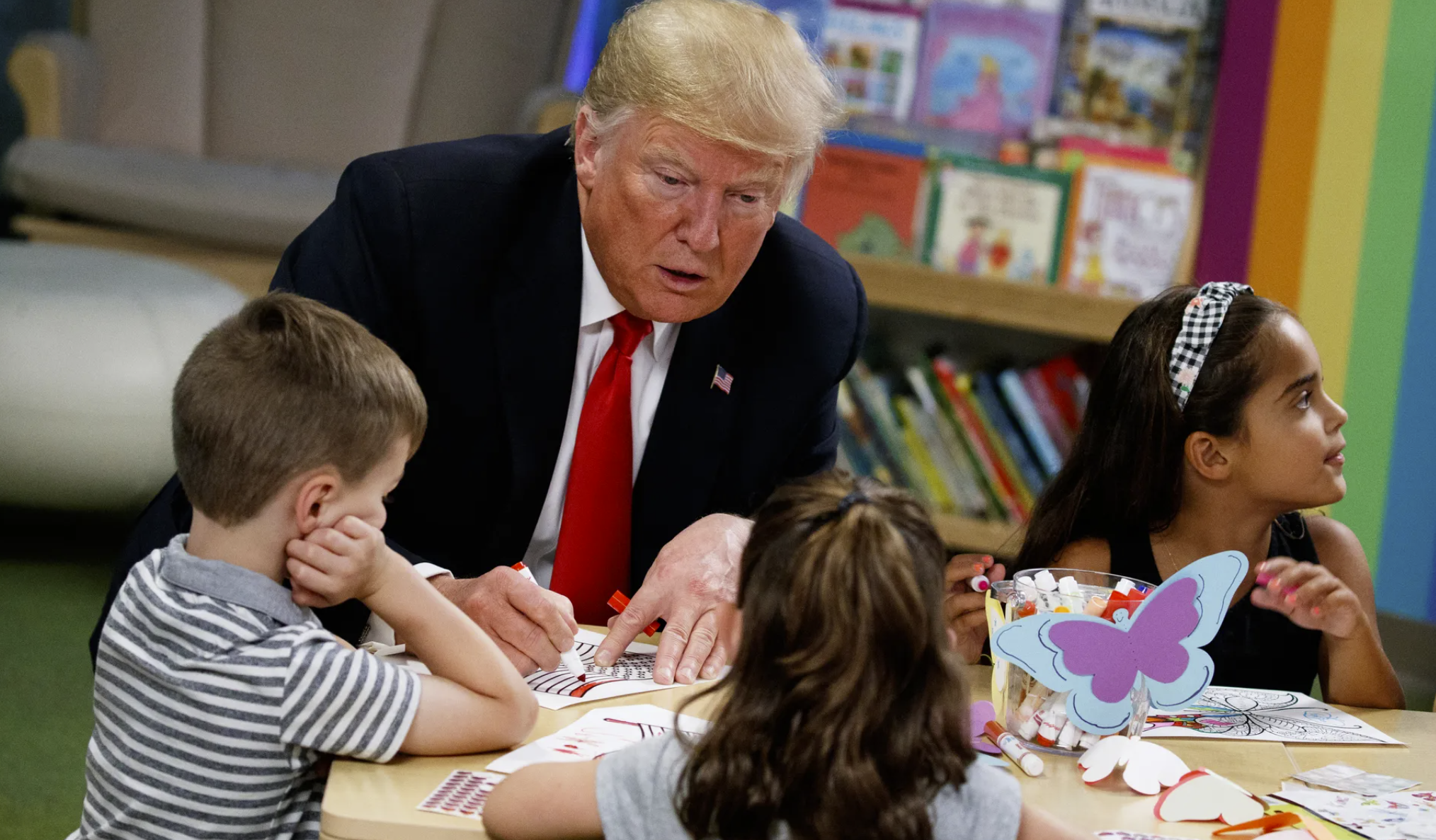 President Donald Trump colors during a visit with a group of children at the Nationwide Children’s Hospital, Aug. 24, 2018, in Columbus, Ohio. (AP Photo/Evan Vucci, File)