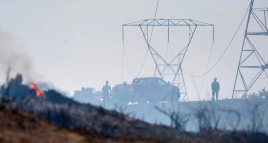 Fire crews keep watch over a wildfire beneath the high tension power lines along 82nd Avenue South in Roy, Washington, on Thursday, July 6, 2023. Tony Overman toverman@theolympian.com