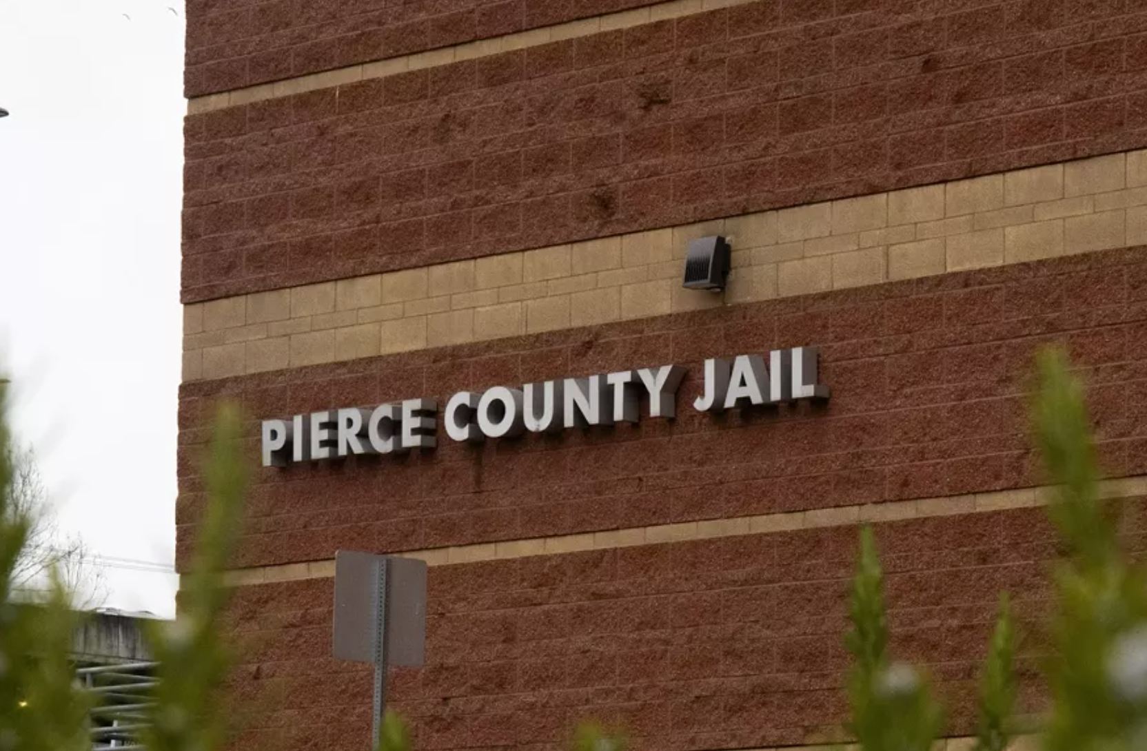 A photograph of the outside of the Pierce County jail, adjacent to the Pierce County Sheriff’s Office in Tacoma. Pierce County installed a distributed antenna system throughout the government complex in 2022 to boost the police radio system, a move state auditors say violates state law. Moe K. Clark/InvestigateWest