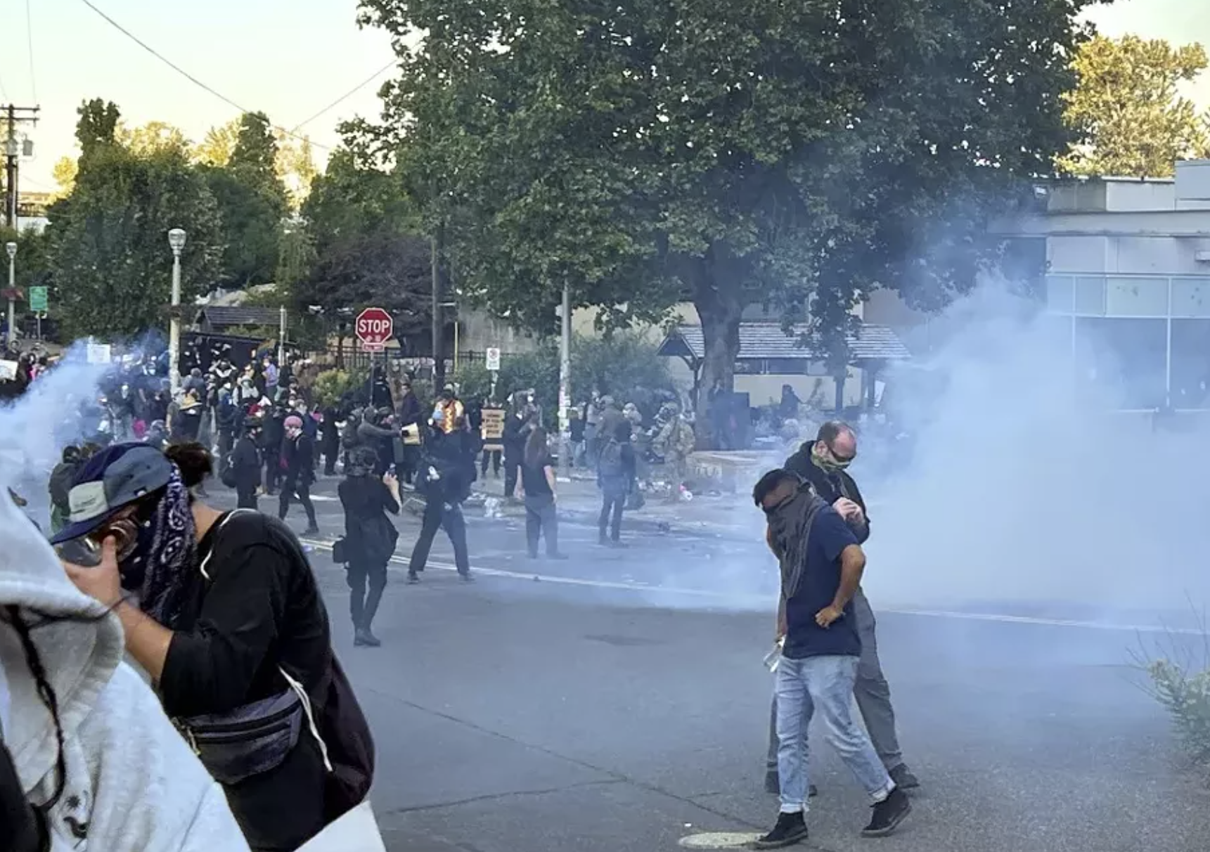 Department of Homeland Security officers deploy crowd control munitions, including tear gas, at a demonstration outside the ICE building on June 14, 2025. Conrad Wilson / OPB
