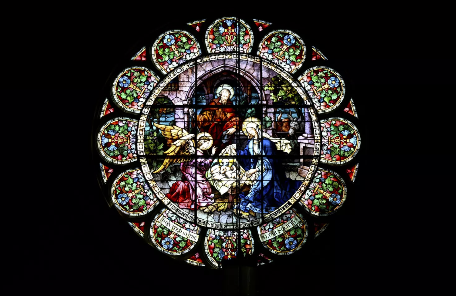 The top stained glass window on the east side of The Cathedral of Our Lady of Lourdes has been cleaned by Bovard Studio Stained Glass, while the bottom set is untouched. (DAN PELLE/THE SPOKESMAN-REVIEW)