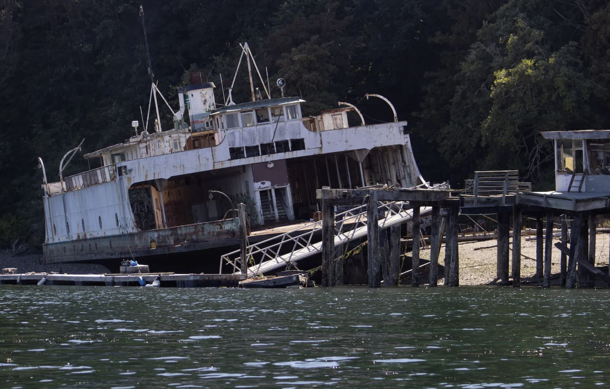 The Olympic, a retired Washington state ferry, is abandoned off Ketron Island in the Puget Sound. State officials cannot remove the vessel due to its large size and location on private property. For 15 years, it hasn’t moved. (Aspen Ford/InvestigateWest)