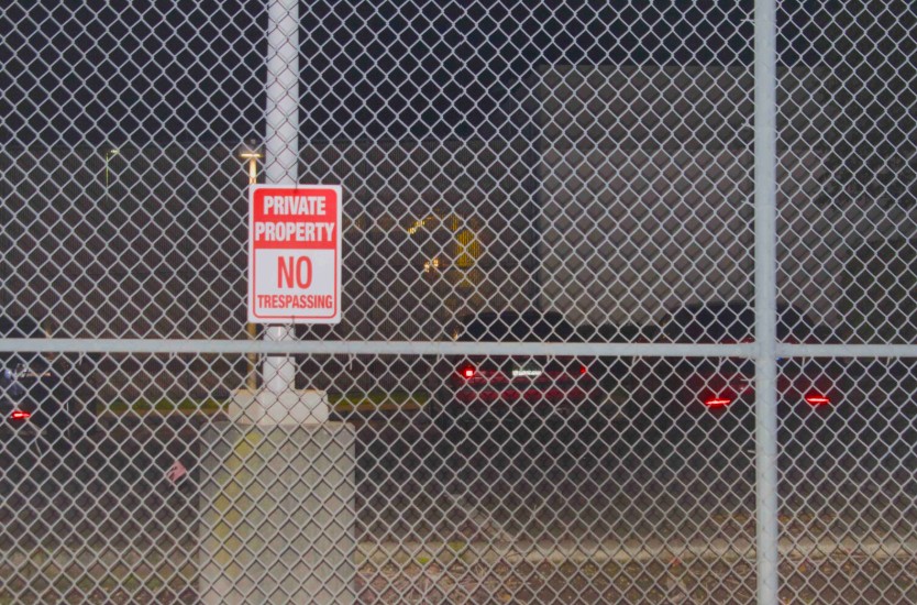 A 'no trespassing' sign on a fence outside the Northwest ICE Processing Center. (Photo by Grace Deng/Washington State Standard)