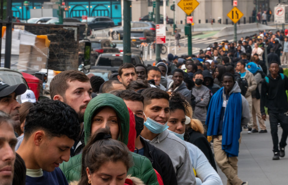 Hundreds of asylum-seekers line up outside the Jacob K. Javits Federal Building in June 2023 in New York City. (Photo by David Dee Delgado/Getty Images)