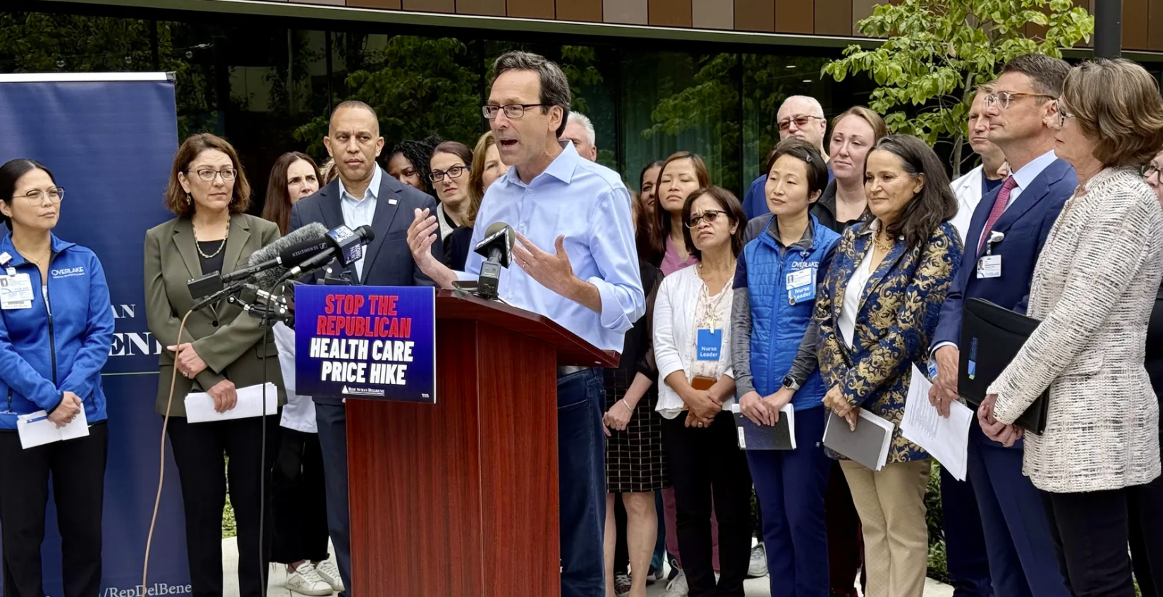 Gov. Bob Ferguson speaks Friday at Overlake Medical Center alongside Washington Insurance Commissioner Patty Kuderer (far right) and members of Congress. Photo: Melissa Santos/Axios