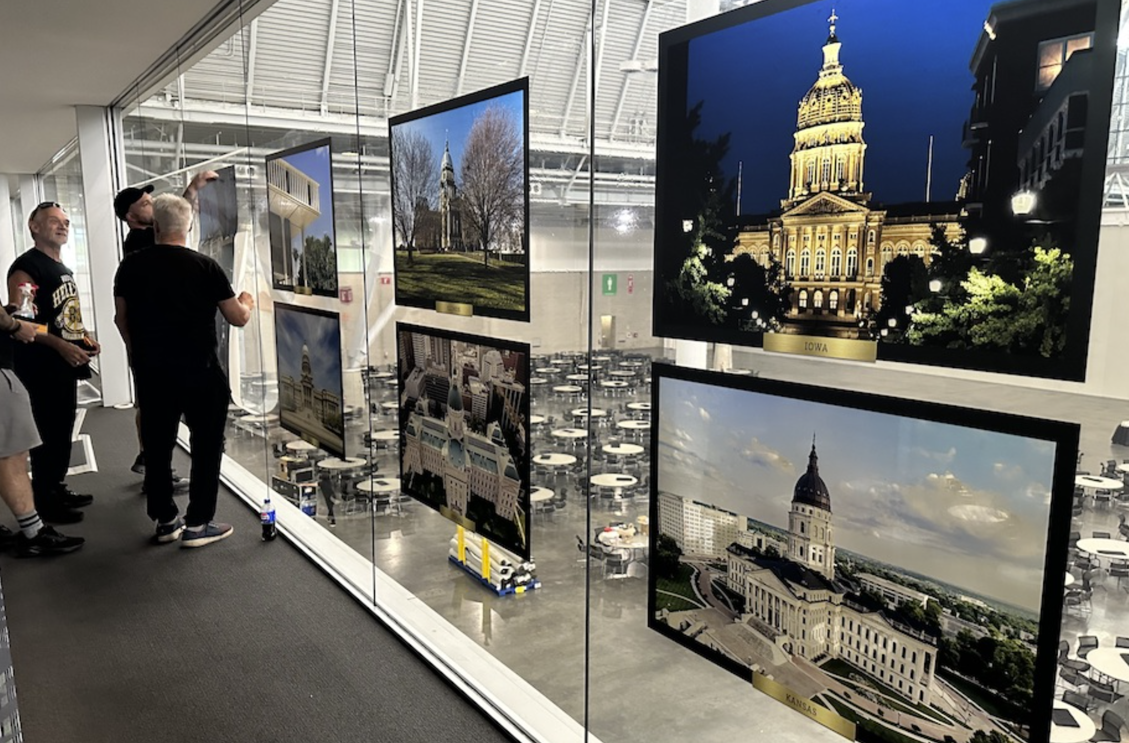 Crews install portraits of state capitol buildings ahead of the National Conference of State Legislatures annual summit on Aug. 4 in Boston. NCSL has asked the Trump administration to stop its review of state laws it says are overly burdensome on business. (Photo by Kevin Hardy/Stateline)