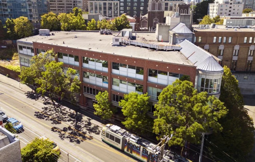 A First Hill street car heads southbound on Broadway past the former Polyclinic building, Aug. 21. King County is planning to open a mental health crisis center on Capitol Hill, at the building, which sits at the... (Ellen M. Banner / The Seattle Times)