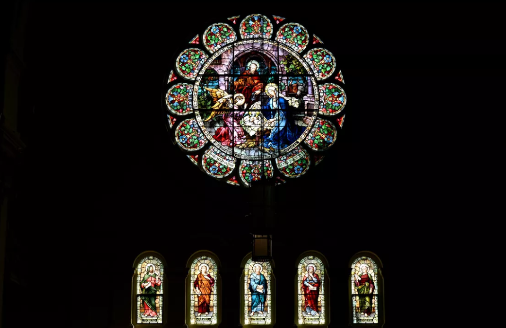 The top stained glass window on the east side of The Cathedral of Our Lady of Lourdes has been cleaned by Bovard Studio Stained Glass, while the bottom set is untouched. (DAN PELLE/THE SPOKESMAN-REVIEW)