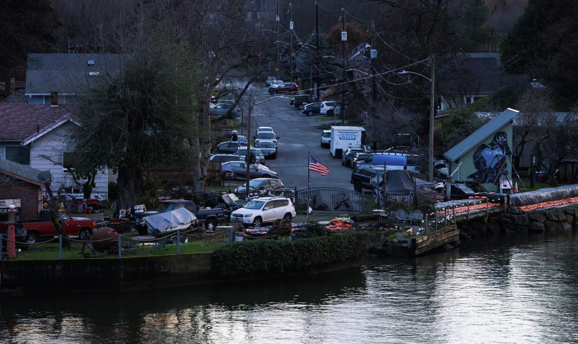 Sandbags line areas of the Duwamish River to help protect Seattle’s South Park neighborhood from flooding in December 2024. The government shutdown has paused the federal National Flood Insurance Program, which provides the vast majority of flood insurance nationwide. (Erika Schultz / The Seattle Times)