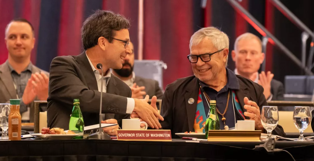 Washington Gov. Bob Ferguson, left, shakes hands with Cowlitz Indian Tribe Chairman Bill Iyall after signing an executive order to improve the state’s relations with tribal governments Monday. (Courtesy of the Washington Office of the Governor)