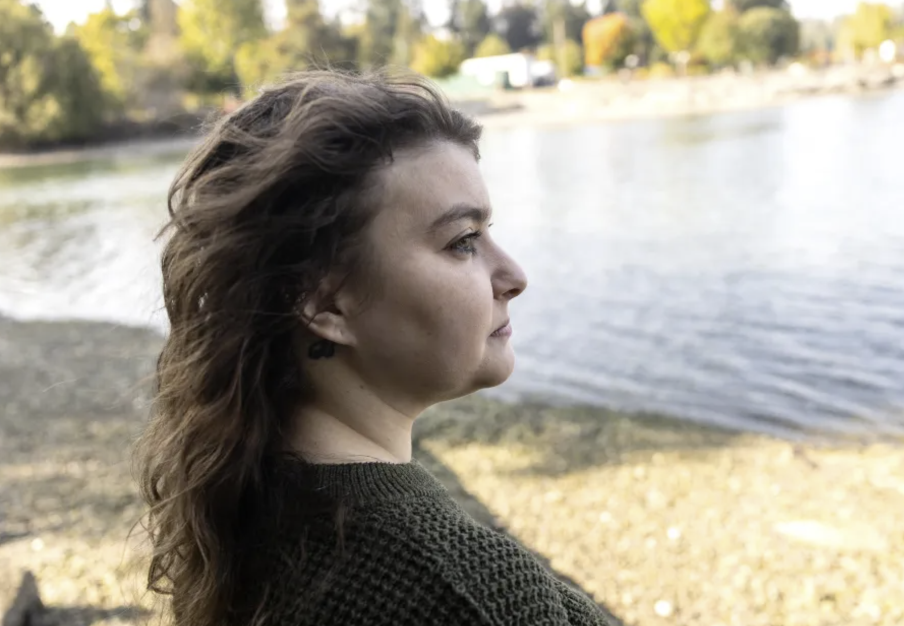 Lauryn Berg, 32, at Evergreen Rotary Park in Kitsap County, Wash. on September 23, 2025. Berg secured a domestic violence protection order against her ex-husband in August 2024, which required him to surrender all of his guns to law enforcement. Although Berg’s ex-husband turned in two handguns, she fears that he can still access other guns he owned during their relationship. (Mike Kane/InvestigateWest)