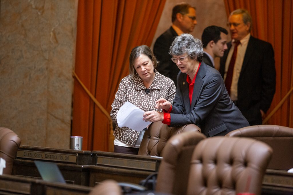 Reps. Cody and Robinson looking over legislation on the floor