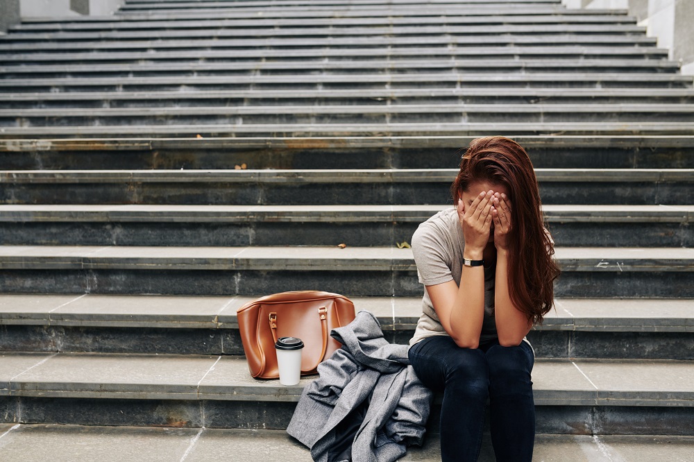 Crying woman sitting on steps