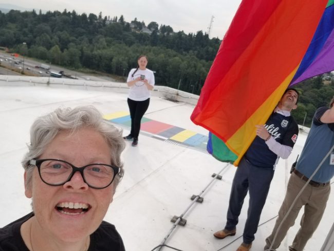 Rep. Jinkins selfie on top of Tacoma Dome with Pride flag