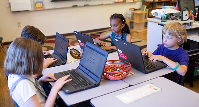 elementary school students working on computers