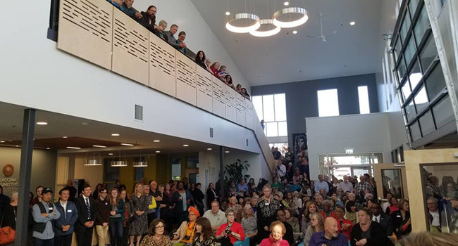 Community members attending a grand opening of Tacoma Community House