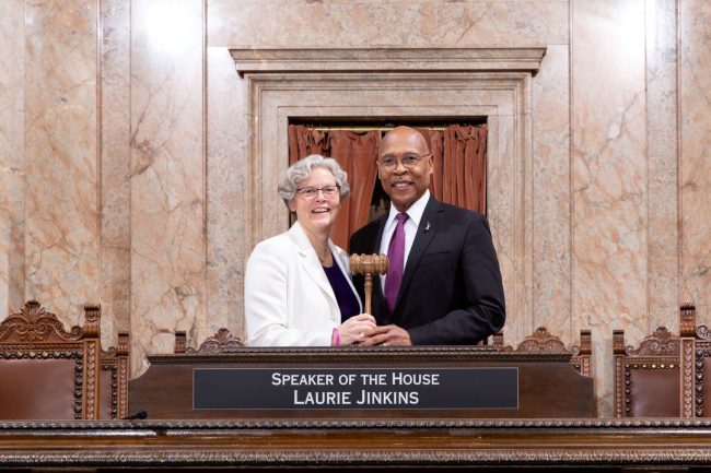 Speaker Laurie Jinkins (D-Tacoma) Deputy Speaker Pro Tempore John Lovick (D-Mill Creek) at the House rostrum jointly holding gavel.