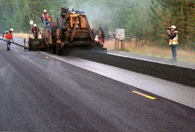 road construction crew on rural highway paving