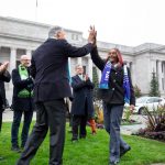 Rep. Morgan and Governor Inslee high five in the flag circle