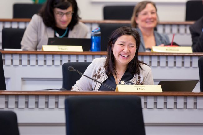 Rep. Thai sitting on dais smiling