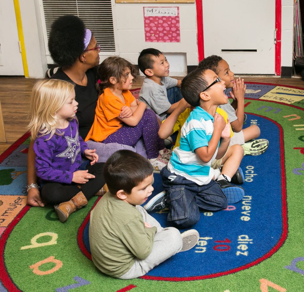 children listening during story time at their early learning center