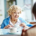 Retiree talking with friends over coffee