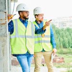 Workers discussing location of construction