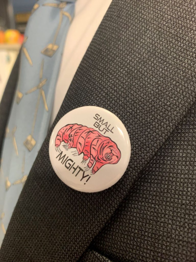 A pin showing a picture of a tardigrade with the text "Small but mighty"