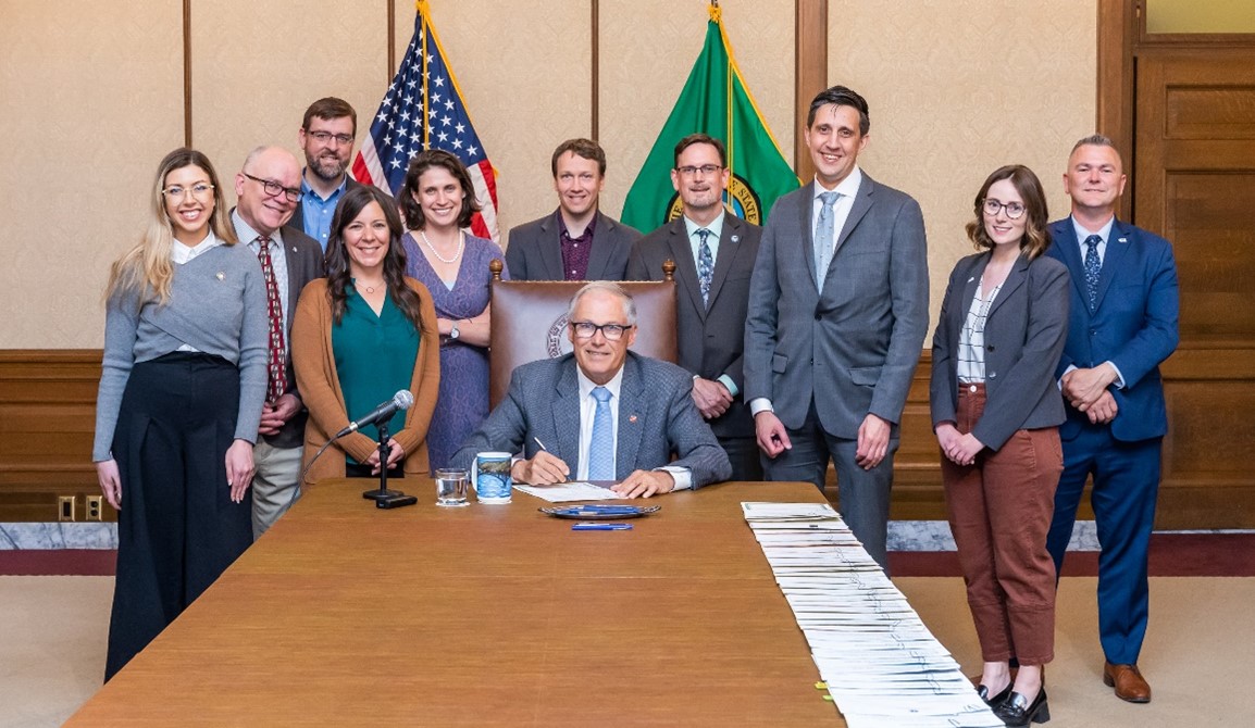 Rep. Ramel and stakeholders at a bill signing with Governor Jay Inslee