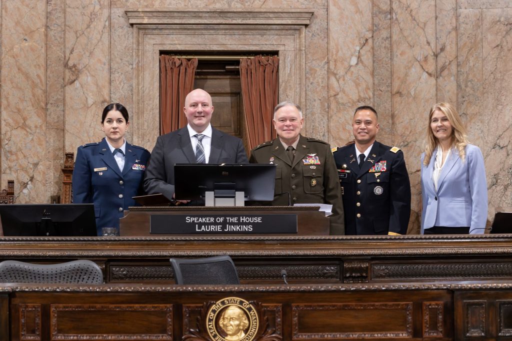 Reps. Bronoske and Orwall and members of the National Guard behind the dias.