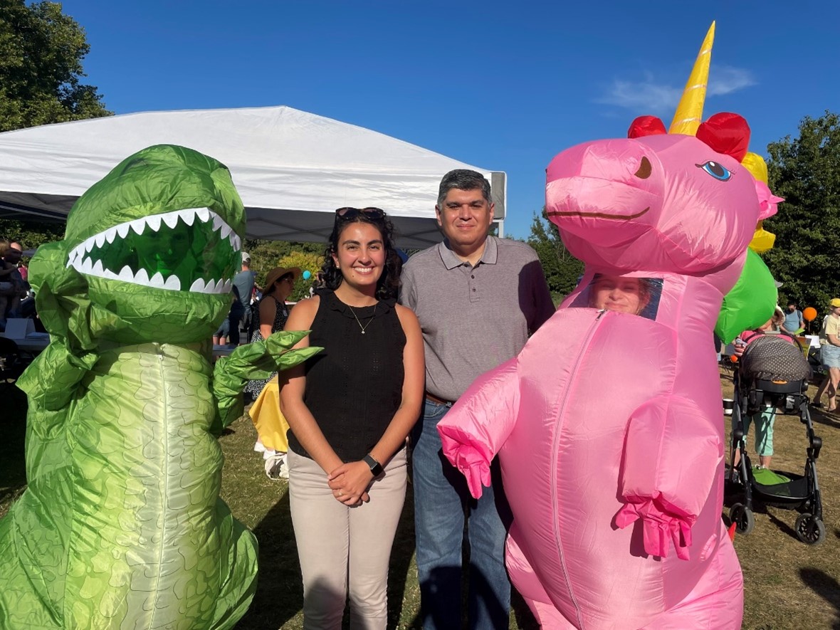 Sen. Valdez and Rep. Farivar take a picture with two prehistoric dinos in honor of the state dinosaur.
